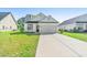 Charming single-Gathering home showcasing a well-manicured lawn and a convenient two-car garage at 4363 Bayshore Dr., Little River, SC 29566