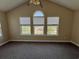 Bright bedroom featuring vaulted ceiling, three windows, and neutral carpet providing a comfortable living space at 4394 Daphne Ln. # F, Murrells Inlet, SC 29576