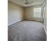 Spacious bedroom featuring a ceiling fan, window, closet with sliding doors, and plush carpeting at 4394 Daphne Ln. # F, Murrells Inlet, SC 29576