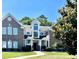 Inviting exterior of a two-story townhome with a well-manicured lawn and a beautifully designed facade at 4394 Daphne Ln. # F, Murrells Inlet, SC 29576