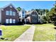Charming two-story townhome featuring a well-kept lawn and inviting walkway leading to the entrance at 4394 Daphne Ln. # F, Murrells Inlet, SC 29576