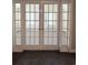 Inviting view through French doors to a sunlit room with neutral carpeting and ample natural light at 4394 Daphne Ln. # F, Murrells Inlet, SC 29576