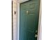 Close-up of the front door, featuring a dark green finish, classic knocker, and secure lockset at 4394 Daphne Ln. # F, Murrells Inlet, SC 29576