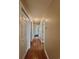 Well-lit hallway with hardwood-style floors and multiple doors leading to various rooms in the home at 4394 Daphne Ln. # F, Murrells Inlet, SC 29576