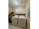 Efficient laundry room with washer, dryer, water heater, and storage cabinets for convenience at 4394 Daphne Ln. # F, Murrells Inlet, SC 29576