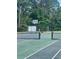Community tennis court surrounded by trees, offering a great place to play at 4394 Daphne Ln. # F, Murrells Inlet, SC 29576