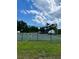 A view of the community's tennis court from behind the perimeter fence and grassy border at 4394 Daphne Ln. # F, Murrells Inlet, SC 29576