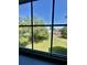 Window view showcasing a lush green yard, mature trees and car parking lot beyond at 4394 Daphne Ln. # F, Murrells Inlet, SC 29576