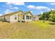 Home exterior with a grassy backyard that backs up to a wooded area at 454 Sean River Rd., Conway, SC 29526