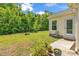 Lush backyard with grassy area, mature trees, and a patio area at 454 Sean River Rd., Conway, SC 29526