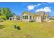 Spacious backyard with green grass and exterior view of house at 454 Sean River Rd., Conway, SC 29526
