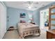 Light blue bedroom with a ceiling fan, a comfy quilt bed, and an unique sliding barn door at 454 Sean River Rd., Conway, SC 29526