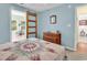 Light blue bedroom with a bed with a quilt, dresser, sliding door and glimpse into the sunroom at 454 Sean River Rd., Conway, SC 29526