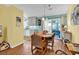 Cozy dining area with hardwood floors, view of the kitchen, and sliding glass doors to the backyard at 454 Sean River Rd., Conway, SC 29526