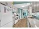 Galley kitchen with stainless steel appliances, tile backsplash, and white cabinets, offering a clean, modern design at 454 Sean River Rd., Conway, SC 29526
