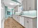 Bright kitchen featuring white cabinets, granite countertops, tile backsplash, and modern appliances at 454 Sean River Rd., Conway, SC 29526