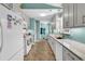 Galley kitchen with stainless steel appliances, tile backsplash, and white cabinets, offering a clean, modern design at 454 Sean River Rd., Conway, SC 29526