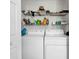 Functional laundry area with a side-by-side washer and dryer and shelving above at 454 Sean River Rd., Conway, SC 29526