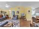 Bright living room with hardwood floors, a ceiling fan, and a doorway leading to the kitchen at 454 Sean River Rd., Conway, SC 29526