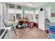 Sunroom featuring light green walls, wood flooring, and large windows at 454 Sean River Rd., Conway, SC 29526