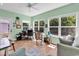 Bright sunroom with lots of windows looking out to the trees, a ceiling fan, and beautiful herringbone floors at 454 Sean River Rd., Conway, SC 29526
