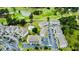 Aerial view of property showcasing the pond, golf course, community pool, buildings, and ample parking at 4783 Wild Iris Dr. # 101, Myrtle Beach, SC 29577