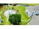 Community pool surrounded by palm trees, lush green spaces, and pristine landscaping at 4783 Wild Iris Dr. # 101, Myrtle Beach, SC 29577