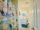 Bright bathroom with updated vanity and shower featuring beach themed shower curtain at 4783 Wild Iris Dr. # 101, Myrtle Beach, SC 29577