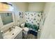 Well-lit bathroom featuring nautical-themed decor, a white sink vanity, and a shower with marine life curtain at 4783 Wild Iris Dr. # 101, Myrtle Beach, SC 29577