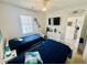 Bright bedroom with twin beds, TV, dresser, and beach themed decor at 4783 Wild Iris Dr. # 101, Myrtle Beach, SC 29577