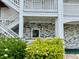 Well-maintained condo entrance with tidy landscaping and convenient stair access at 4783 Wild Iris Dr. # 101, Myrtle Beach, SC 29577