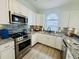Modern kitchen boasts stainless steel appliances, granite counters, and decorative backsplash at 4783 Wild Iris Dr. # 101, Myrtle Beach, SC 29577