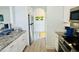 Bright kitchen features white cabinets, stainless steel appliances, and granite countertops at 4783 Wild Iris Dr. # 101, Myrtle Beach, SC 29577
