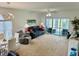 Spacious living room filled with natural light, comfortable seating, and an adjacent sunroom for relaxing at 4783 Wild Iris Dr. # 101, Myrtle Beach, SC 29577