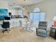 Open living space boasts white cabinetry, a desk area, stylish lighting, and modern furnishings at 4783 Wild Iris Dr. # 101, Myrtle Beach, SC 29577