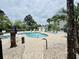 Community pool surrounded by lounge chairs, palm trees and bathroom facility at 4783 Wild Iris Dr. # 101, Myrtle Beach, SC 29577