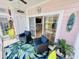 Bright sun room featuring tropical decor, wicker furniture, and tile flooring at 4783 Wild Iris Dr. # 101, Myrtle Beach, SC 29577