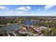 Aerial view of condo community with lake, golf course, and lush greenery under a blue sky at 501 Maison Dr. # G-14, Myrtle Beach, SC 29572