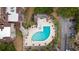 Aerial view of the community pool with hot tub, set amongst lush landscaping and residential buildings at 501 Maison Dr. # G-14, Myrtle Beach, SC 29572