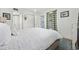 Bright bedroom with white bedding, closet, and bathroom access, enhanced by natural light at 501 Maison Dr. # G-14, Myrtle Beach, SC 29572