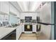 Galley kitchen featuring stainless steel appliances, white cabinets, and wood floors at 501 Maison Dr. # G-14, Myrtle Beach, SC 29572