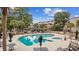 Community pool with lounge chairs and tables with umbrellas, surrounded by manicured landscaping near condo buildings at 501 Maison Dr. # G-14, Myrtle Beach, SC 29572