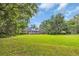 Large backyard featuring a well-manicured lawn and brick house with screened porch at 520 Chapman Loop, Pawleys Island, SC 29585