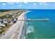 Aerial view of a pristine beach with a long fishing pier stretching into the ocean on a sunny day at 520 Chapman Loop, Pawleys Island, SC 29585