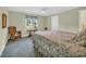 Relaxing bedroom with a floral bedspread, green walls, and window views of the outdoor scenery at 520 Chapman Loop, Pawleys Island, SC 29585