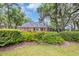 Beautiful brick home showcasing lush landscaping and moss-draped trees at 520 Chapman Loop, Pawleys Island, SC 29585