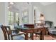 Living room with a table, chairs, large bright windows, and screened porch at 520 Chapman Loop, Pawleys Island, SC 29585