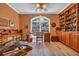 Inviting home office with custom built-ins, wood floors, and a large window overlooking the yard at 520 Chapman Loop, Pawleys Island, SC 29585