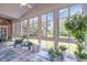 Light-filled sunroom with large windows offering views of the landscaped backyard at 520 Chapman Loop, Pawleys Island, SC 29585