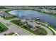 An aerial view shows a playground, lake with fountain, pier, and a well-maintained neighborhood at 5406 Longhorn Dr., Myrtle Beach, SC 29588